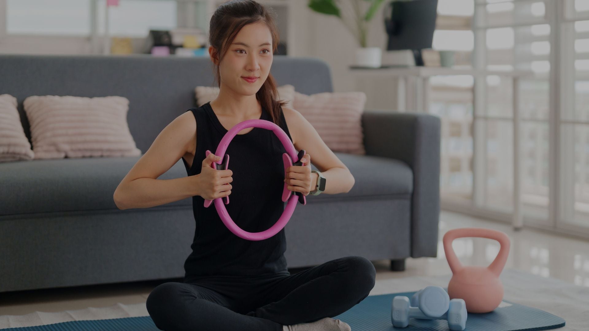 woman using pilates ring during relaxing home wellness workout session
